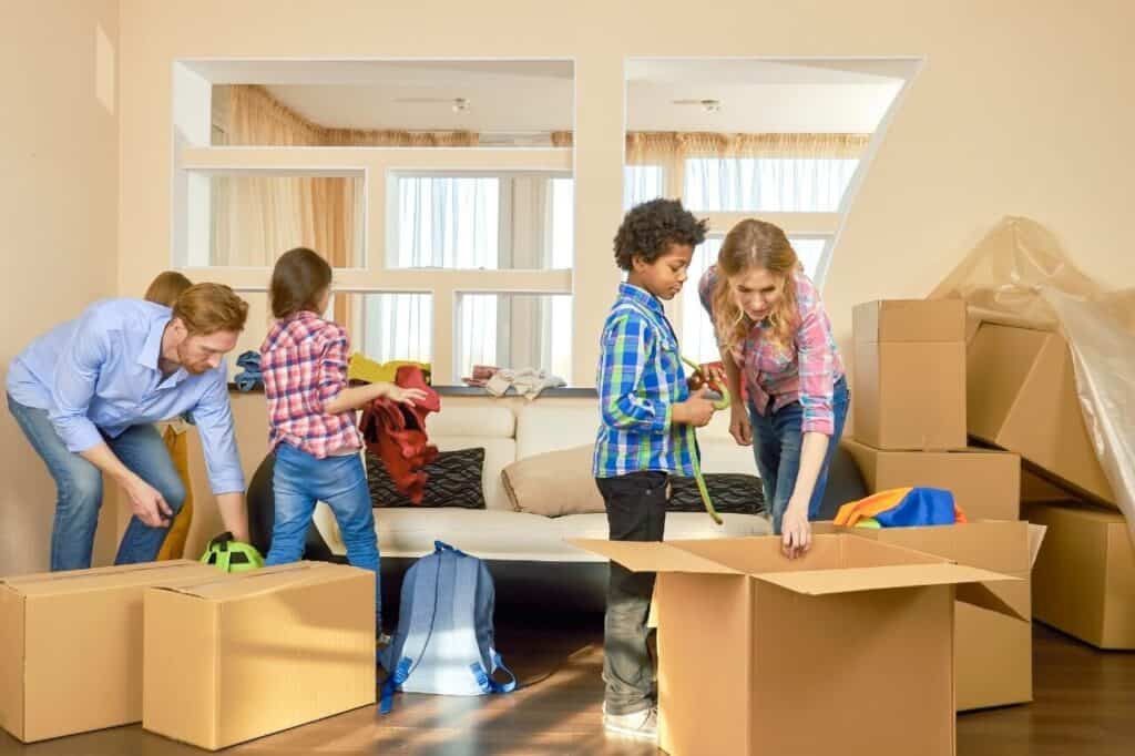 A happy family is packing up removal boxes for moving to the new home