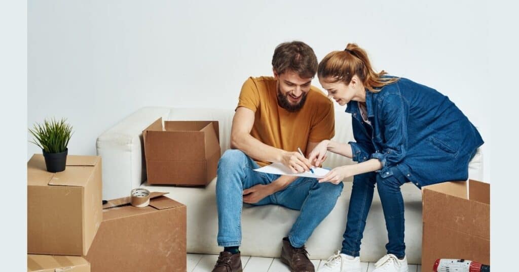 A couples is packing boxes for moving home