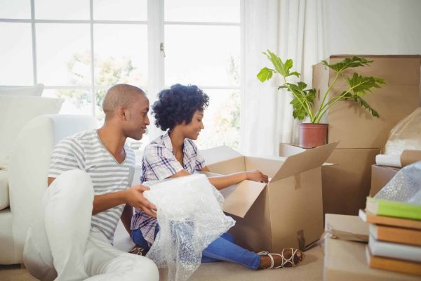 A couples unpacking stuff from the moving boxes