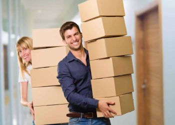 A couples are packing up boxes for storage before moving