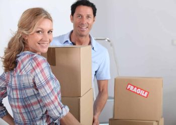 A woman and a man are moving boxes ready for removals